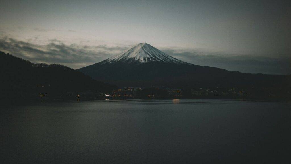 Minimalist photograph of Mount Yōtei at dusk emphasizing misty peaks